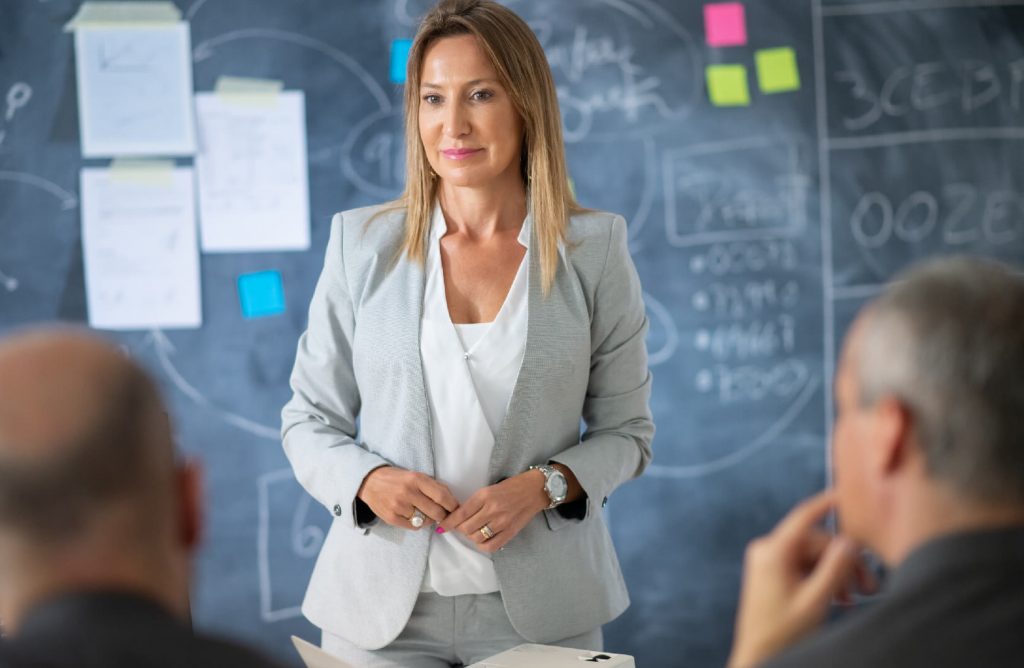 Portrait company female leader meeting serious woman suit listening her colleagues reports analyzing information preparing set new tasks targets business growth strategy concept
